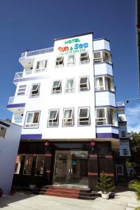 a white building with a sign on it at Sun & Sea Hotel in Phu Quoc
