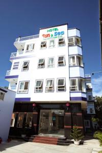 a white building with a sign on it at Sun & Sea Hotel in Phú Quốc