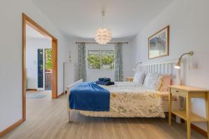 a bedroom with a bed with a teddy bear on it at Studio SeaSky Tabua by Holiday Rental Madeira in Ribeira Brava