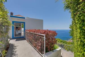 a house with a balcony with a view of the ocean at Studio SeaSky Tabua by Holiday Rental Madeira in Ribeira Brava