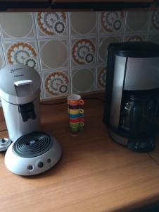a coffee maker next to a coffeemaker on a counter at Gîte la fourmilière in Morbier