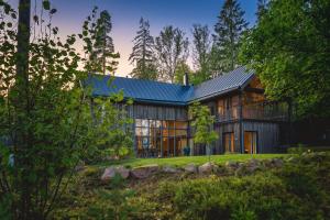 a large house with a metal roof at Stay North - Peikkola in Kirkkonummi