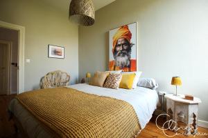 a bedroom with a bed with a painting on the wall at Evasion in Albi +27 photos