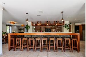 a kitchen with a large wooden bar with stools at La Casona de Omaña in Fasgar