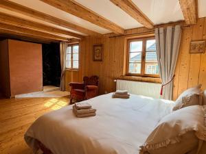 a bedroom with a large bed with towels on it at L'Héritage 1779 in Duntzenheim +54 photos