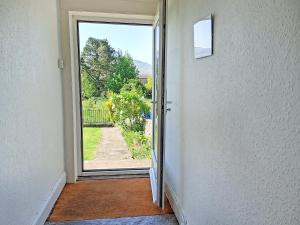an open door with a view of a yard at Lilac Cottage in Hawes