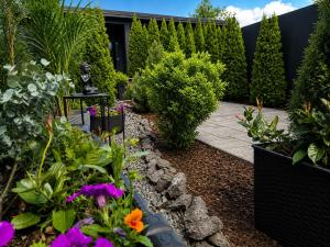 a garden with plants and flowers in a yard at Vila GARUFA Wellness & Spa in Vysoké Tatry