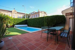 a patio with a table and chairs and a pool at Evasion in Albi