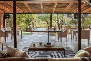an outdoor living room with tables and chairs at Taj Bush Lodge in Hoedspruit
