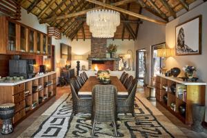a dining room with a table and chairs at Taj Bush Lodge in Hoedspruit