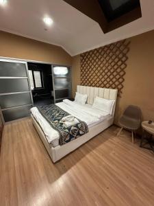 a bedroom with a bed and a table and a chair at Gatsby Ortosay in Orto-Say +58 photos