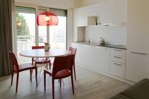 a kitchen with a table and chairs in a kitchen at Residence Dolce Vita in San Benedetto del Tronto