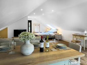 a living room with a table with wine bottles at Gatherley Loft in Scorton