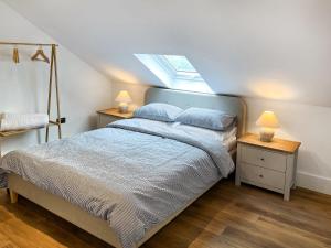 a bedroom with a bed with two night stands at Gatherley Loft in Scorton