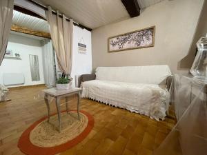 a living room with a bed and a table at Studio de charme in Breil-sur-Roya