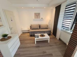 a small living room with a couch and a table at Apartment Jan im Dangaster Nest in Varel