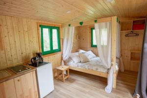 a bedroom with a bed in a wooden cabin at Hébergements Insolites Camping la Pinède des Mées in Les Mées