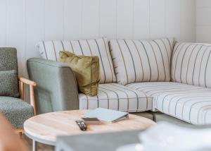 a living room with a couch and two chairs at The Astbury Golf And Lodge Resort in Bridgnorth