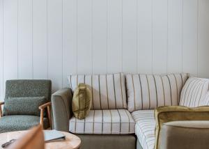 a living room with a couch and two chairs at The Astbury Golf And Lodge Resort in Bridgnorth