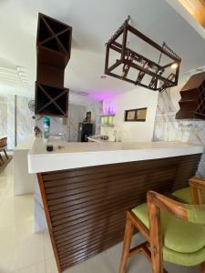 a kitchen with a counter and a bar with chairs at Casa Buenafe in Antipolo