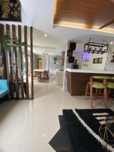 a living room with a kitchen and a dining room at Casa Buenafe in Antipolo
