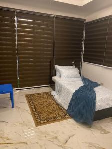 a bedroom with a bed and a large window at Casa Buenafe in Antipolo +21 photos