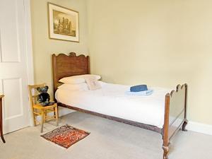 a bedroom with a bed in a room at Lochside Stable Hse in Town Yetholm +7 photos