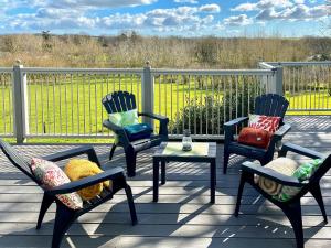 a patio with chairs and a table and a fence at Wattles-E4527 in Uplowman