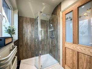 a bathroom with a shower with a glass shower stall at Talltrees - Uk42842 in Uplowman
