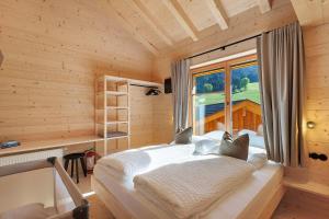 a bedroom with a bed in a room with a window at Archerhof in Racines
