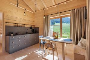 a kitchen with a table and a large window at Archerhof in Racines