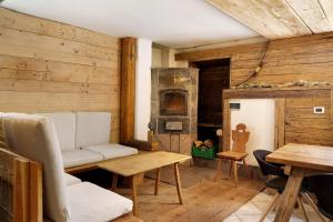 a living room with a couch and a wood stove at Baita Dal Bigolaro in Levico Terme