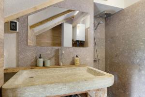 a bathroom with a sink and a mirror at Baita Dal Bigolaro in Levico Terme