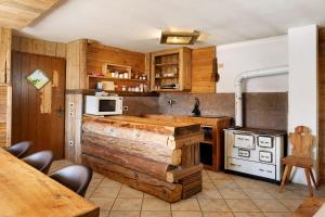 a kitchen with a wooden counter top and a stove at Baita Dal Bigolaro in Levico Terme +22 photos