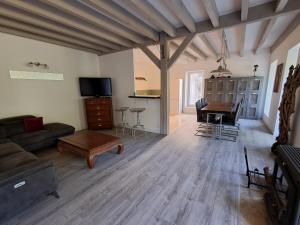 a living room with a couch and a table at Les Jardins du Bateau in Vals-les-Bains