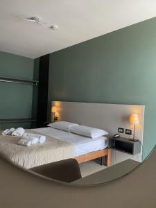 a bedroom with a bed and a mirror at Hotel Futuro in Aversa