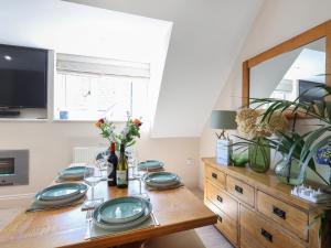 a dining room with a table with plates on it at Kendalls Nook in Shaftesbury