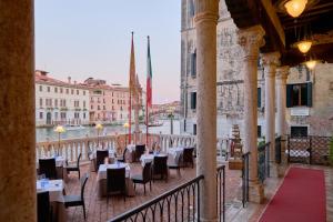 a balcony of a restaurant with tables and chairs at Hotel Palazzo Stern in Venice