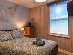 a bedroom with a bed with a view of the ocean at Seagulls Lookout in Weymouth