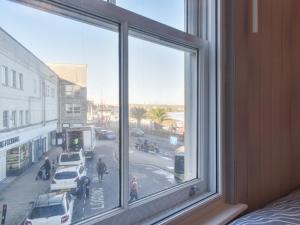 a window with a view of a city street at Seagulls Lookout in Weymouth +7 photos
