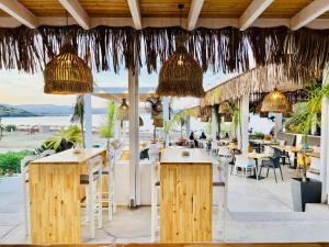 a restaurant with tables and chairs and a view of the ocean at Lindian Jewel Hotel and Villas in Lindos