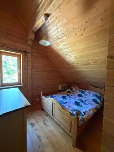 a bedroom with a bed in a wooden cabin at Au bord du lac III in Montigny-en-Morvan