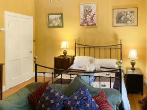 a bedroom with a bed with a teddy bear on it at Lochside Garden House - S4484 in Town Yetholm