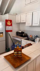 a kitchen with three bottles of honey on a cutting board at Chill room front sea in Philipsburg