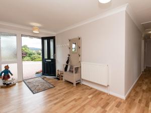 a living room with white walls and a hard wood floor at Sheeoch in Comrie