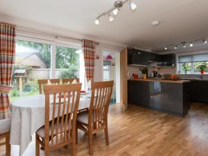 a kitchen and dining room with a table and chairs at Sheeoch in Comrie