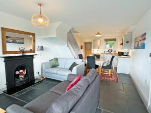 a living room with a couch and a fireplace at Coniston Cottage in Coniston +11 photos