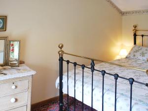 a bedroom with a bed and a dresser at Ryecroft in Bradwell