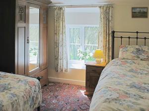 a bedroom with two beds and a window at Ryecroft in Bradwell