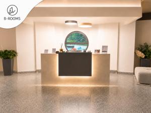 a lobby with a tv and a window at B-ROOMS Bleisure Hotel - Lugano district in Manno